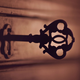 A shadowy key sticks out of an old lock.